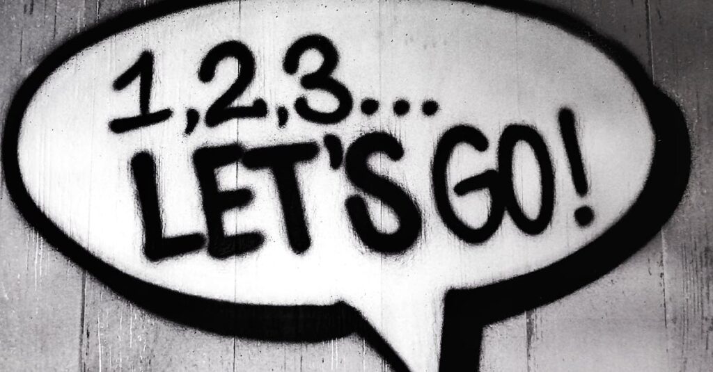 pexels-photo-704767-704767 Black and white street art featuring a bold motivational message in a speech bubble.